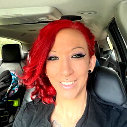 Addylynn, a Georgia-based model with striking red hair and piercings, sharing her car ride experience.