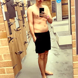 Person in a gym after workout, taking selfie