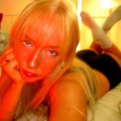 April Mae in a Red Light Room