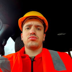 Construction Worker in Orange Safety Jacket and Hard Hat