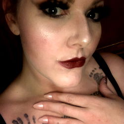 A Woman with Gothic Makeup and Tattoos