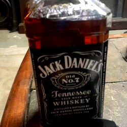 An image of a bottle of Jack Daniels placed on a table