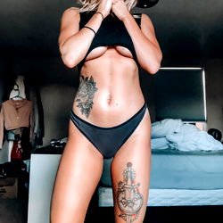 Fitness Model Showcasing Abs and Tattoos