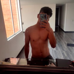 Model in Shirtless Fitness Room