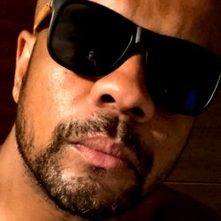 Man in Black Sunglasses Staring at the Camera