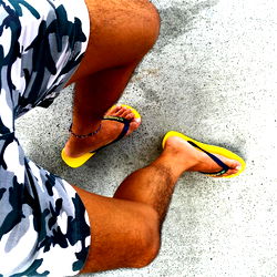 Sexy Man in Camo Swim Trunks and Yellow Flip-Flops
