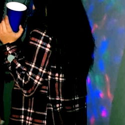 Amber, Captured in a Casual Moment with Phone in Hand at a Social Event