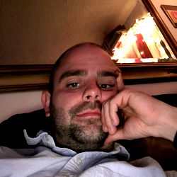 A Man Resting His Head on His Hand