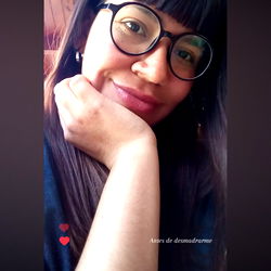 A Young Woman in Glasses and Black Shirt