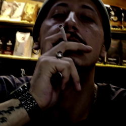 A Man in a Cafe Smoking Cigarette