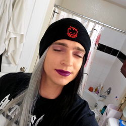 Female Goth Model with Purple Lipstick Posing in Bathroom Mirror