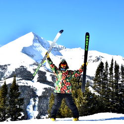 Excited Skiier Celebrating at Top of Mountain