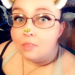 Woman in a cozy setting wearing glasses and a teddy bear filter