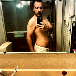 Candid Shot of a Man in a Bathroom Mirror