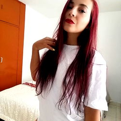 Young woman with vibrant hair and red lipstick in white t-shirt and underwear
