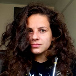 Aixa Lush, a woman with curly hair posing for the camera