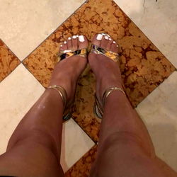 Pretty Feet model showcasing gold sandals and pedicure