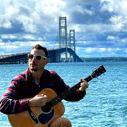 Adagio, musician in front of the Mackinac Bridge