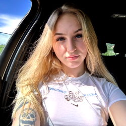 Blonde Woman Taking Selfie in Car