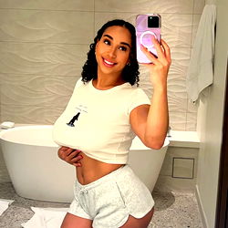 Hazel, an OnlyFans model, taking a selfie in a bathroom