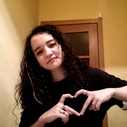A Young Woman Making a Heart Sign