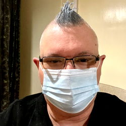 Person in Face Mask with Mohawk and Glasses