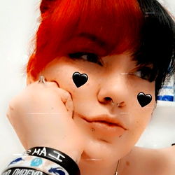 Cool, Red-haired Female with Black Piercings and Heart-shaped Earrings