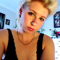 Woman with a nose ring, blond hair and an edgy style