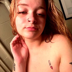 Brat, a model from Onlyfans, in casual attire with tattoos.