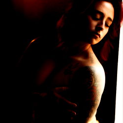 OnlyFans Model Showcasing a Tattooed Woman in Erotic Posture