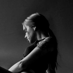 Introspective Olivia, a tattooed adult female