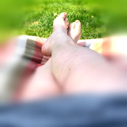 Foot in the air over blanket on lawn chair