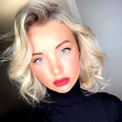 Stylish Blonde Woman in a Chic Black Turtleneck and Red Lipstick,