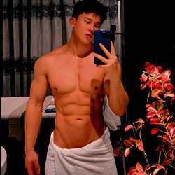 Fit Model Aliray Showcasing Abs and Flexible Pose in Bathrobe