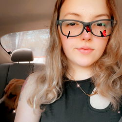 Am, a creative and fun-loving individual captures this playful moment with glasses and a quirky red mustache!