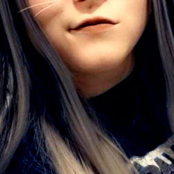 A Photo of Alara, OnlyFans Model with Silver Hair and a Cat-like Expression