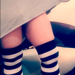 An OnlyFans Model Showcasing Her Striped Socks and Tight Dress