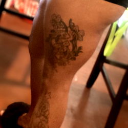 Aja, showcasing her tattoo