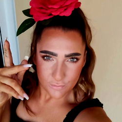 Stylish Person in Black and Red Outfit with Rose Hair Flower