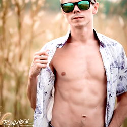 Strong and Shirtless Model Posing in Field