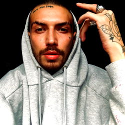 Graydrewlove, a hip-hop artist from the Bronx, expressing himself in front of a graffiti backdrop