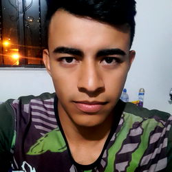 Young Man in Trendy Clothes with Short Hair, Smiling and Looking Directly at the Camera