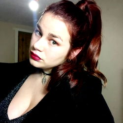 Elegant Female Model with Red Hair, Posing in a Formal Setting