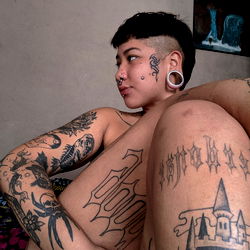 Tattooed OnlyFans Model in Unique Pose