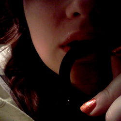 Close-up of a hand holding a ring with a blurred background and watermark