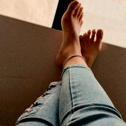 Foot Resting Against Window Sill