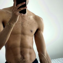 Shirtless Muscular Man Taking Selfie
