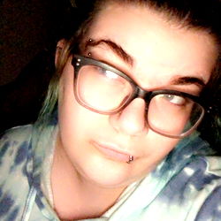 Young Female with Black Glasses and Tie-Dye Shirt