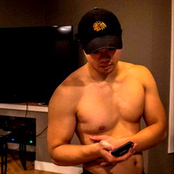 Shirtless Man Checking Cell Phone