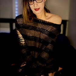 Tarrow, a captivating OnlyFans model posing in a black and white striped tank top